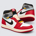 Angled view of Union LA Air Jordan 1 high tops showing red overlays, cream midsoles and blue stitching