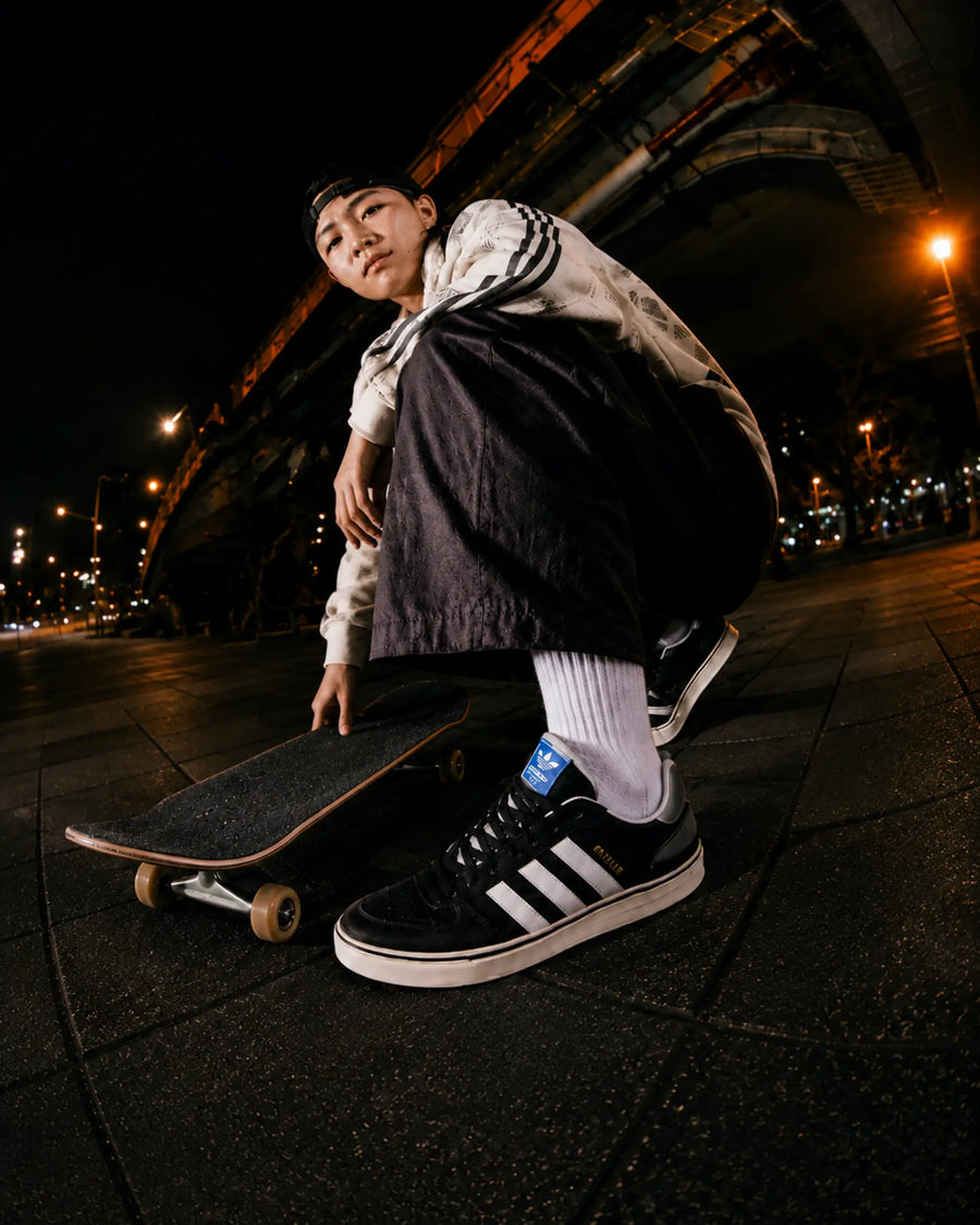 Adidas Superstar skate shoes worn by skateboarder performing a trick in an urban fisheye skate lifestyle scene